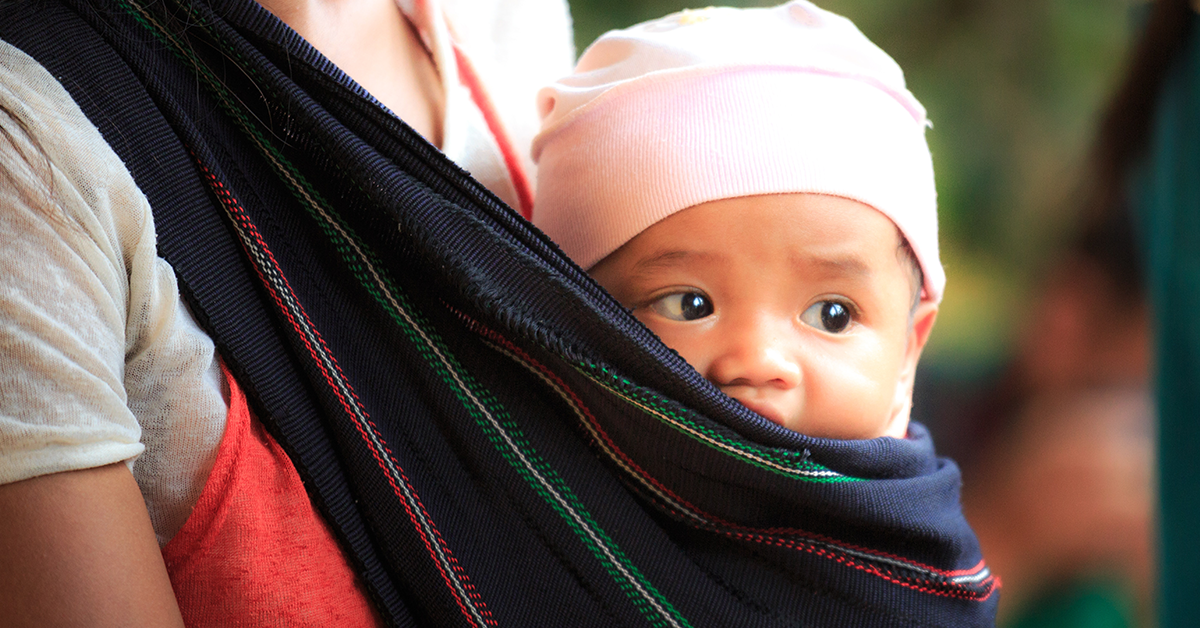 woman carrying asian baby