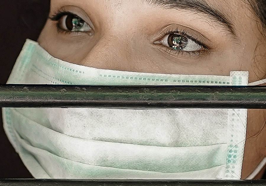 sad woman wearing mask in lockdown