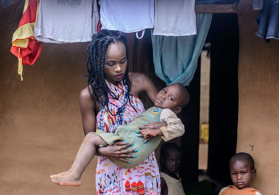 African woman carrying child