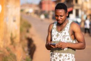 Young man using his phone to access mental health services