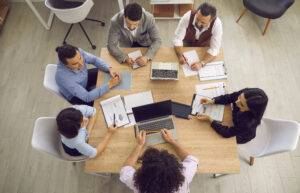 A group of businesspeople looking at charts during a meeting.