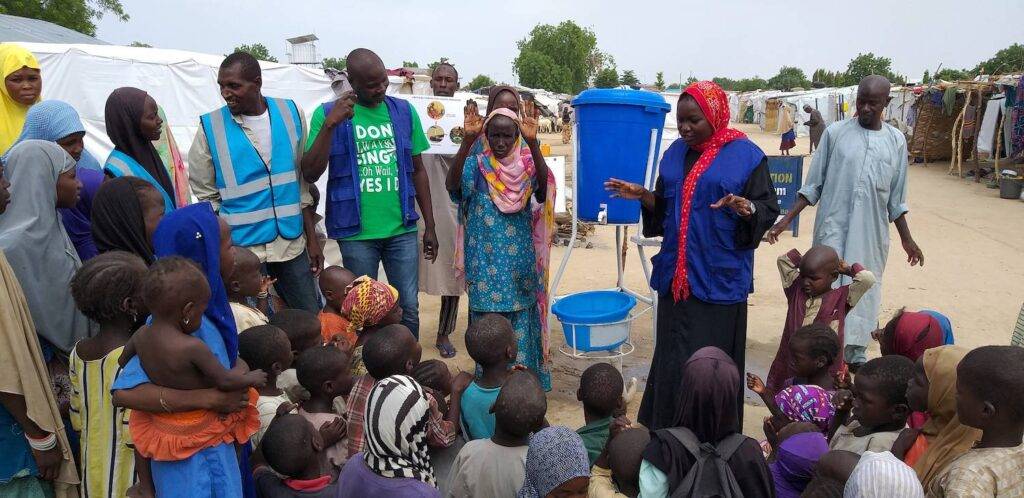A CTG consultant talks to community members about water safety and hygiene in Nigeria.